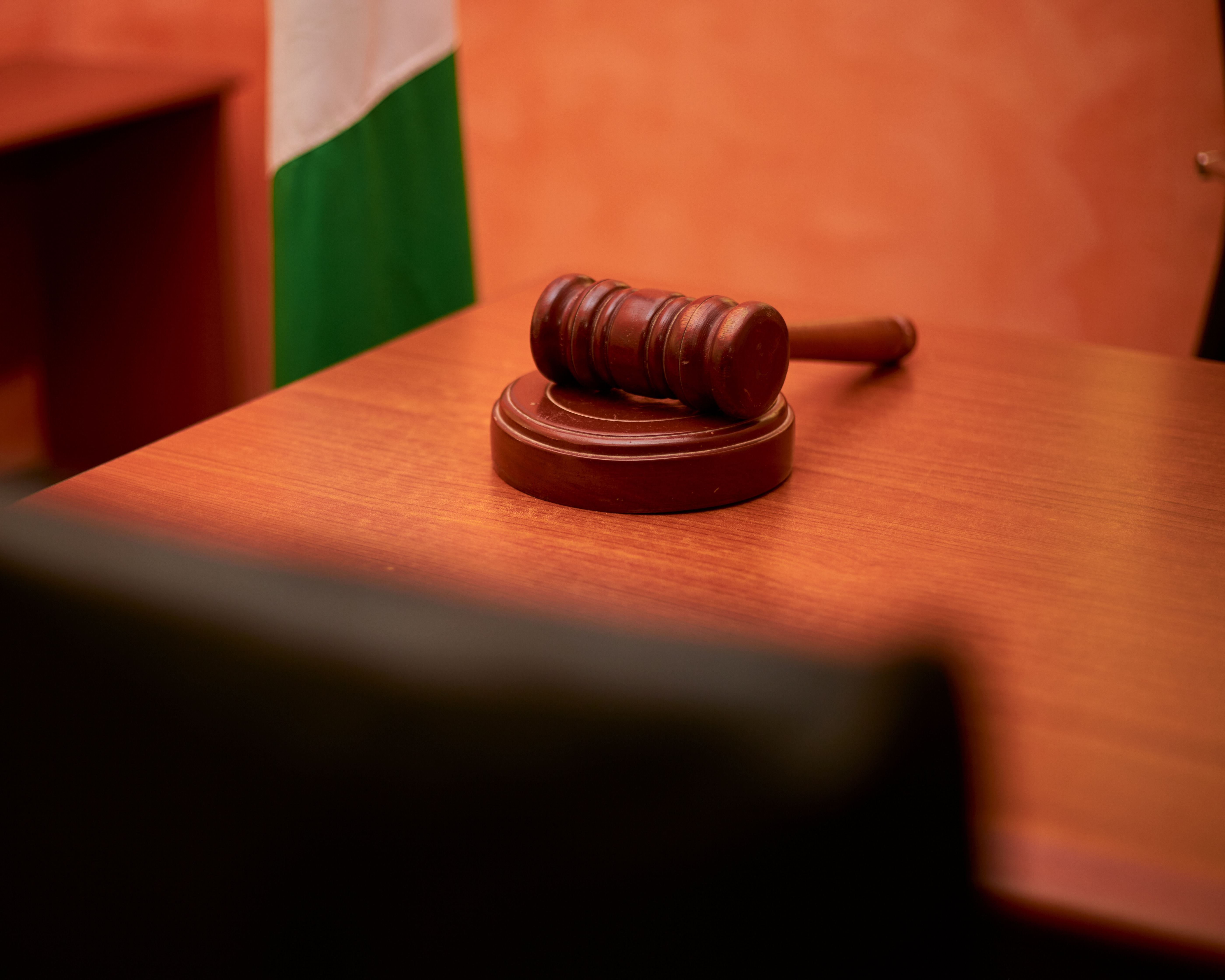 Close-up of a gavel on a courtroom desk representing civil litigation and court costs