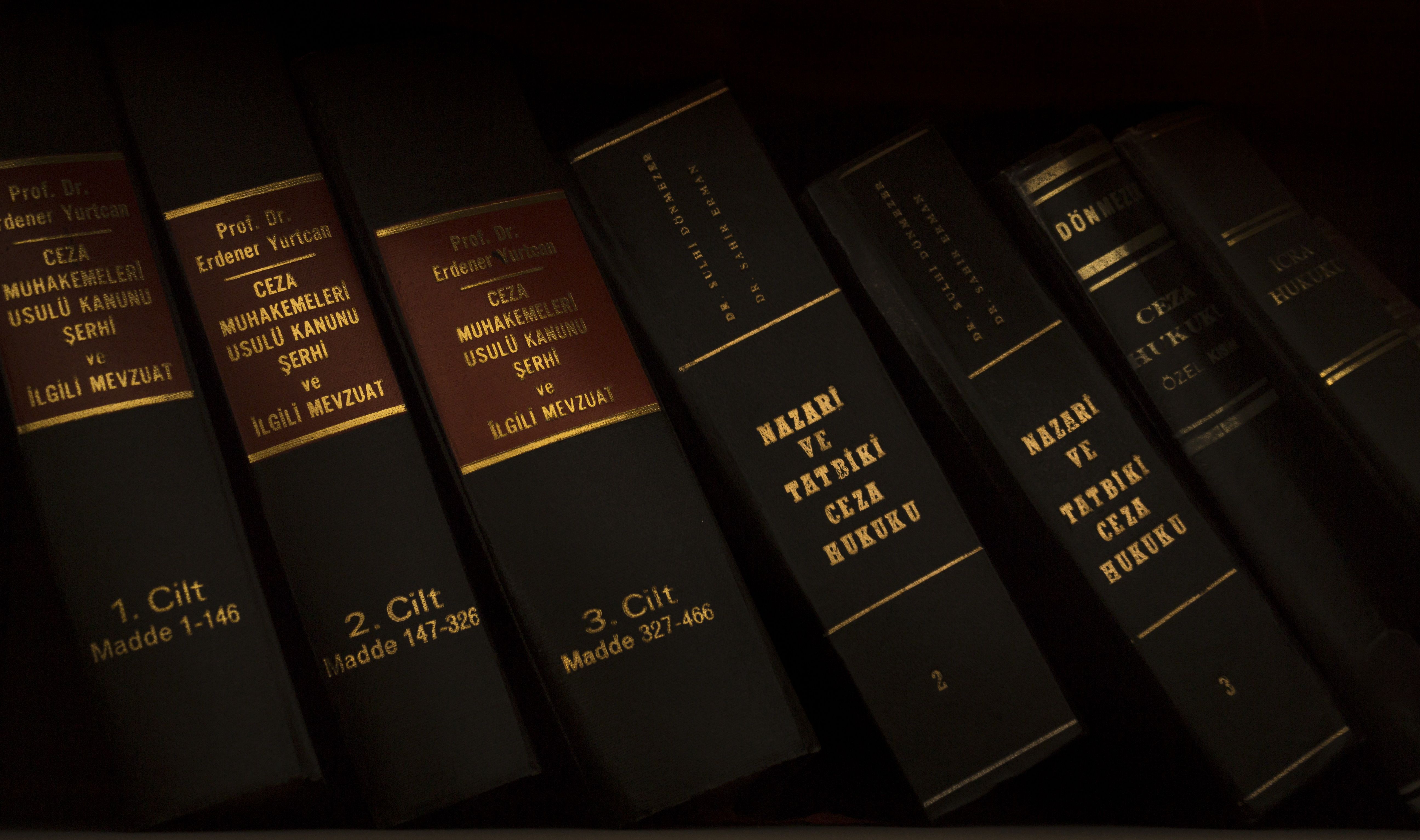 Stack of law books in a legal library used for research in a large civil case